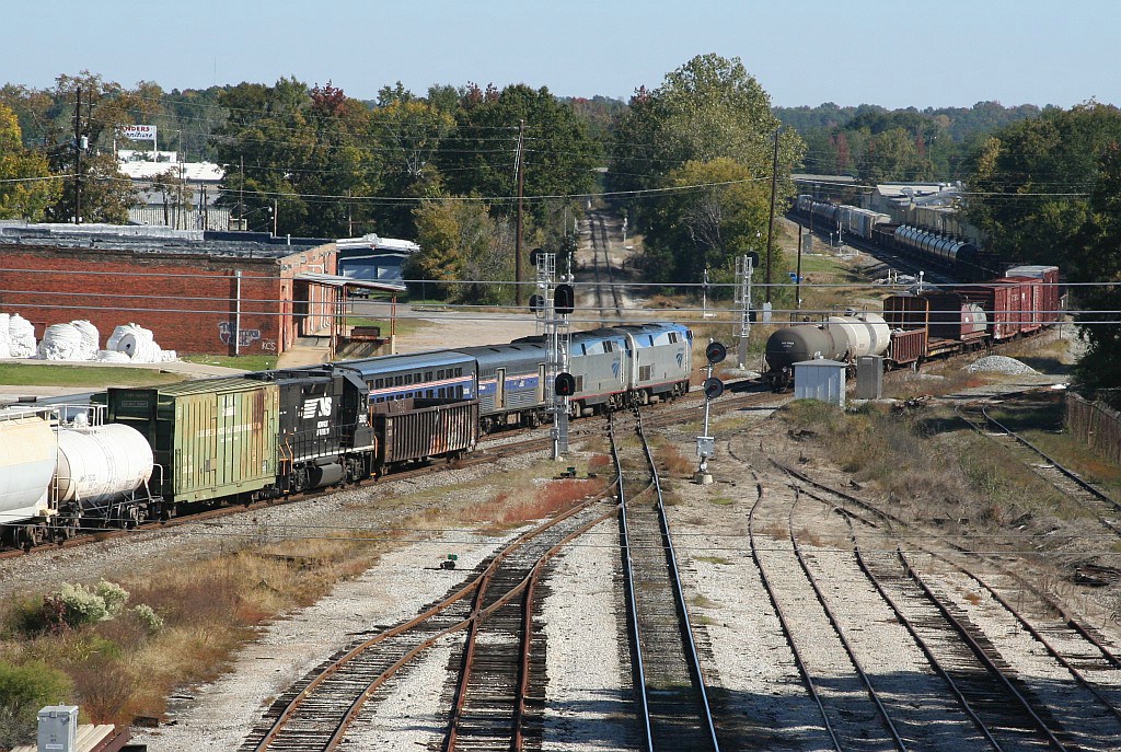 On time NB Crescent going by a freight and a local 